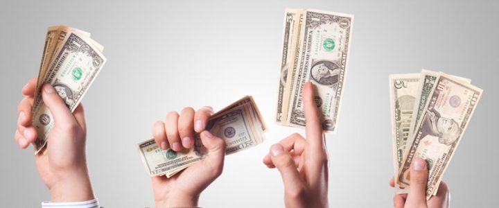 Hands stretching money bills