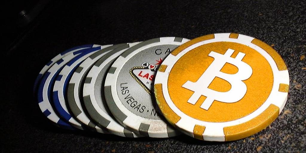A Bitcoin next to poker chips